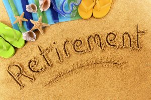 retirement written on beach sand