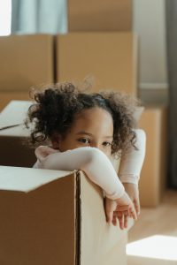 Little girl in moving box.