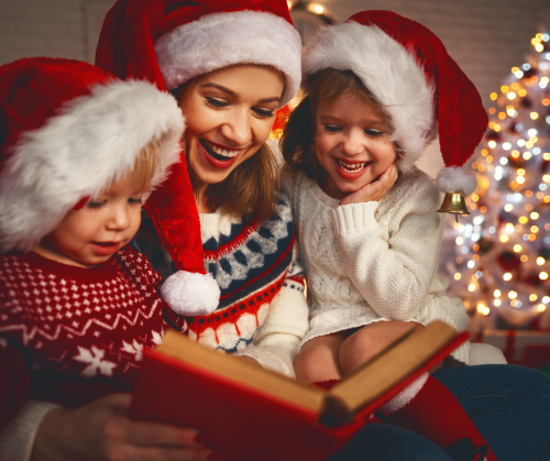 mother with children reading story on Christmas holidays