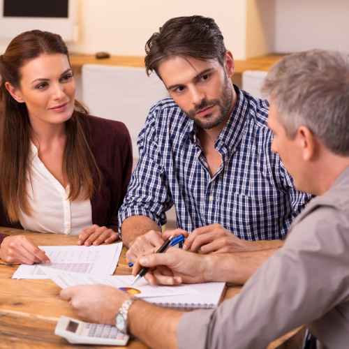 couple sitting at table with financial advisor