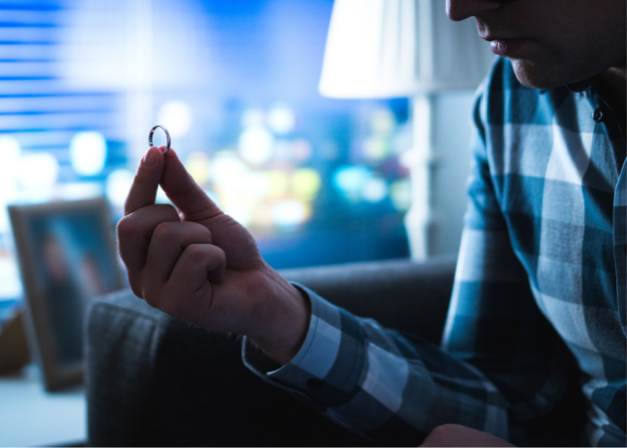 man seriously staring at wedding ring