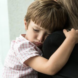 Mother holding upset child