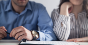 man and woman sitting at a table looking at paperwork