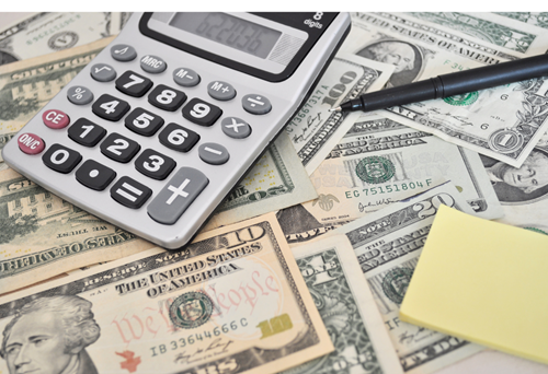 calculator and money on a desk