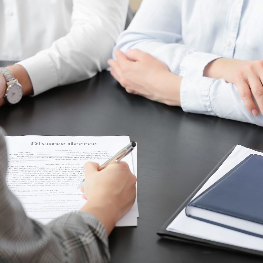 Man and woman sitting at desk with lawyer