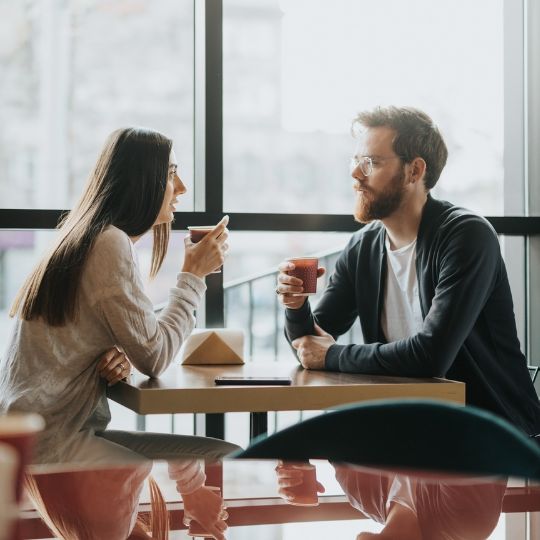 Couple sitting at table talking