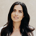 Portrait of a woman with long dark hair and a gentle smile, looking toward the camera.